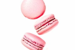 Three pink macaroon cookies isolated on white background