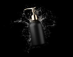 Cosmetic bottle in water splash isolated on black background 3D render, hair and bory care products packaging and branding